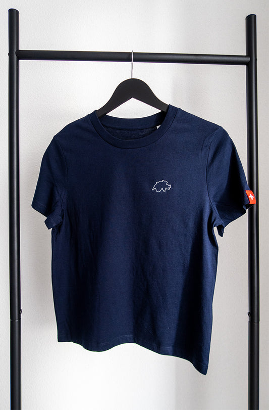 Navy-blaues Twelvetia Damen-T-Shirt mit weiss gestickter Schweizer Landesumrandung auf linker Brust und Schweizer-Flagge-Etikett am linken Ärmel. Hängend an schwarzem Bügel vor weißer Wand.